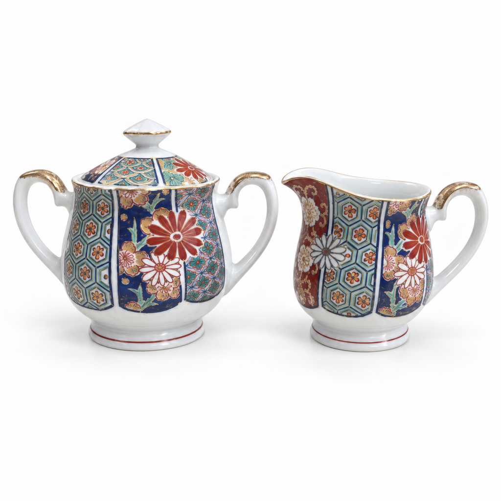 Arita Imari fan pattern lidded sugar bowl and creamer on a white background.