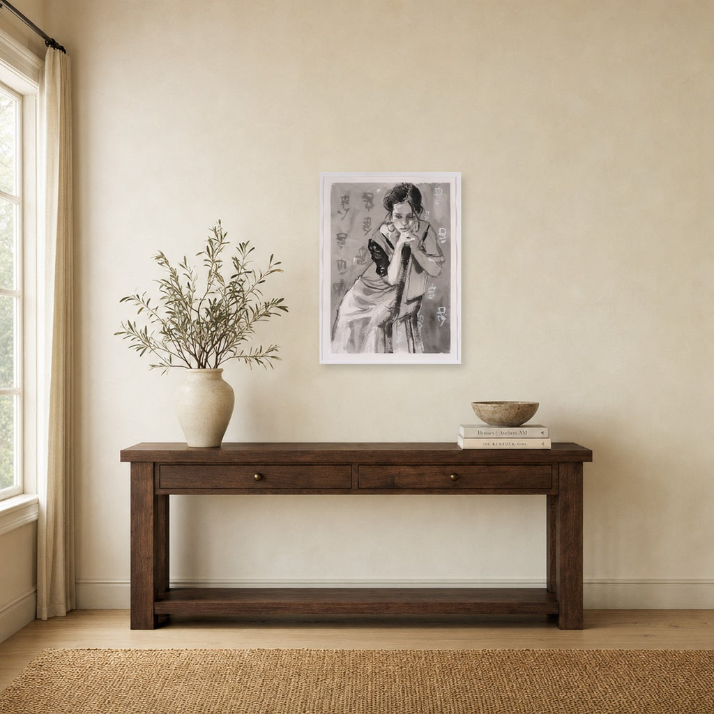 Girl in Chair by Marvin Espy shown to scale on a wall above a wooden console table