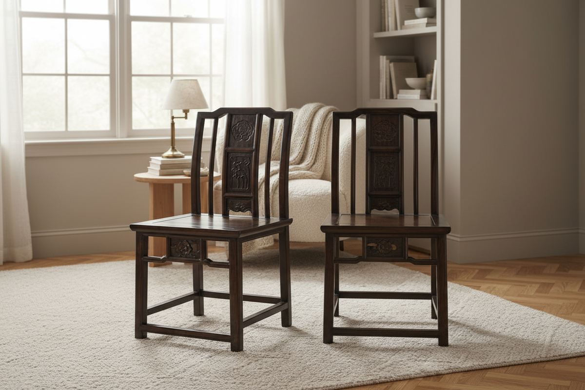 Two antique Chinese carved wood chairs in lifestyle setting