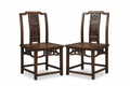 Two antique Chinese carved wood chairs on white background