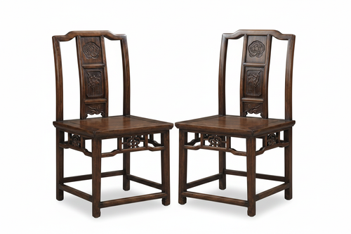 Two antique Chinese carved wood chairs on white background
