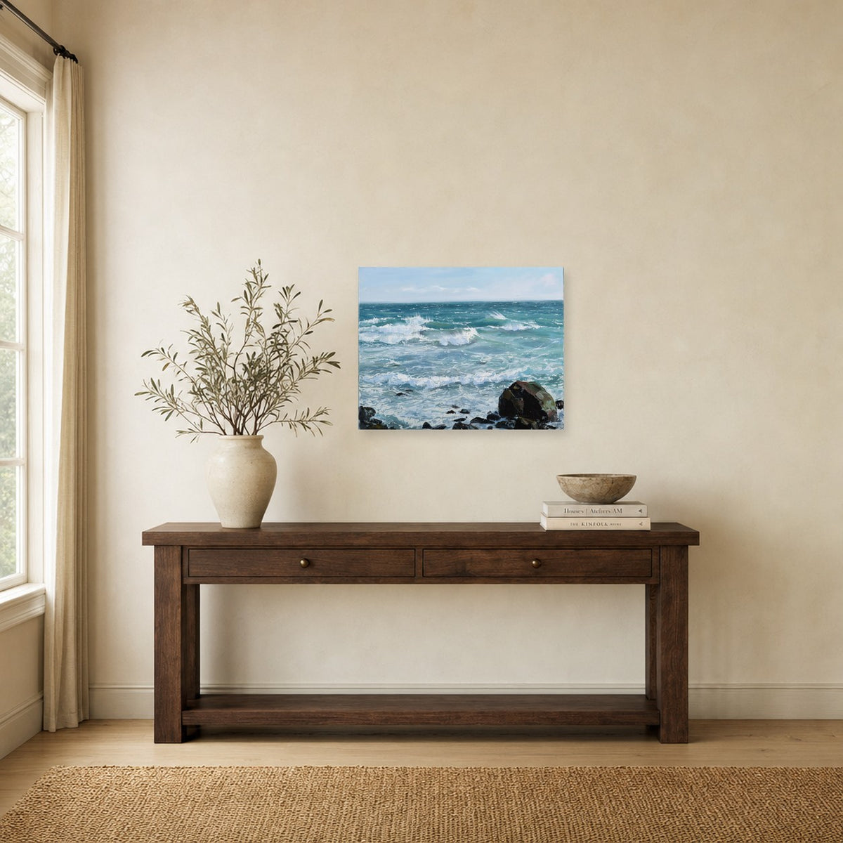 Summer Rocks and Surf II by Annie Wildey shown to scale on a wall above a wooden console table
