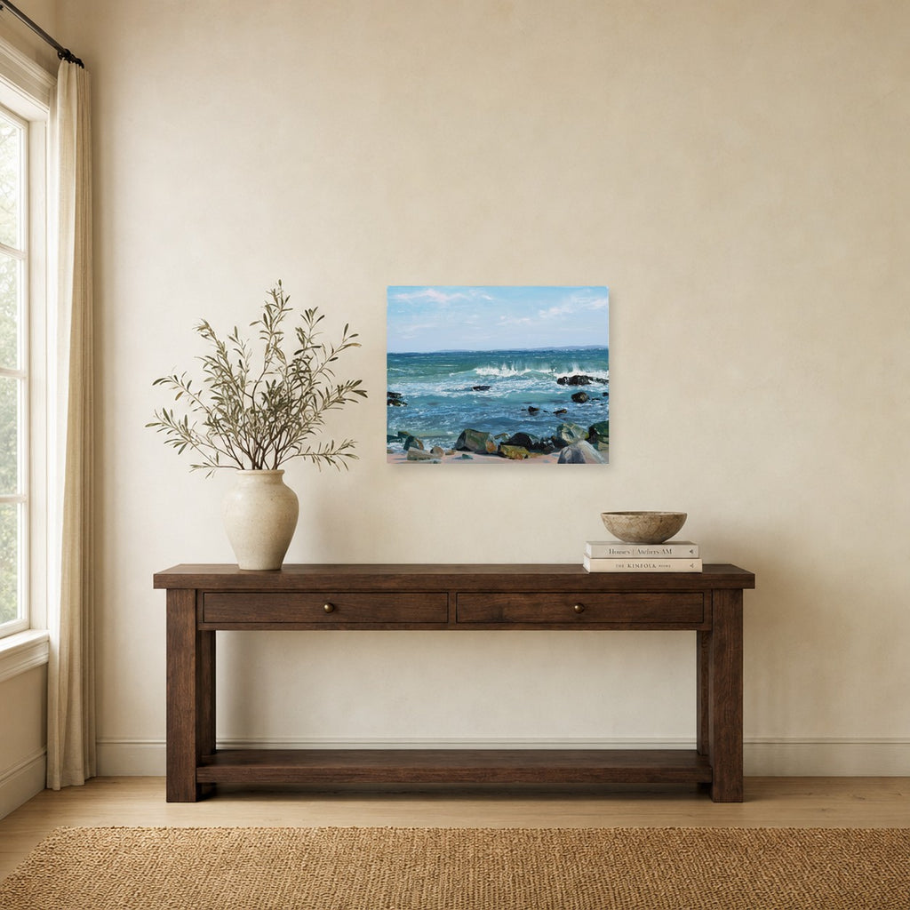 Summer Rocks and Surf IV by Annie Wildey shown to scale on a wall above a wooden console table